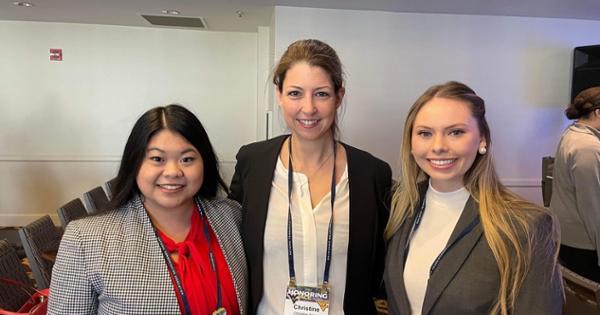 Two students and a teacher smiling