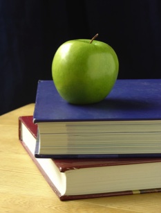 Apple on top of a stack of books