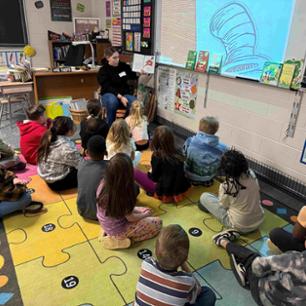 child reading to thing 1 and thing 2