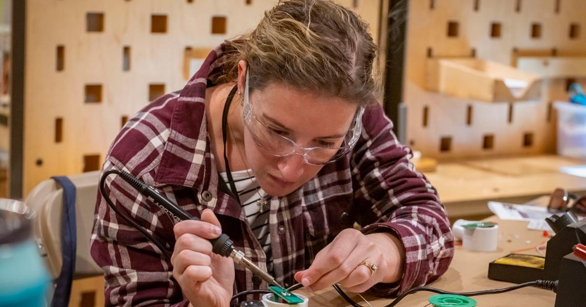 Teacher soldering at workshop 2023