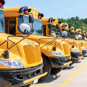 A picture of multiple school busses.