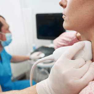 Young woman undergoing an examination of thyroid gland at the endocrinolodist