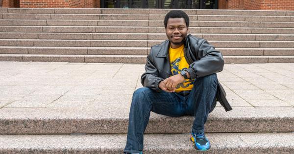 ETSU student Emmanuel Agbagba sitting on the steps of the Charles C. Sherrod Library