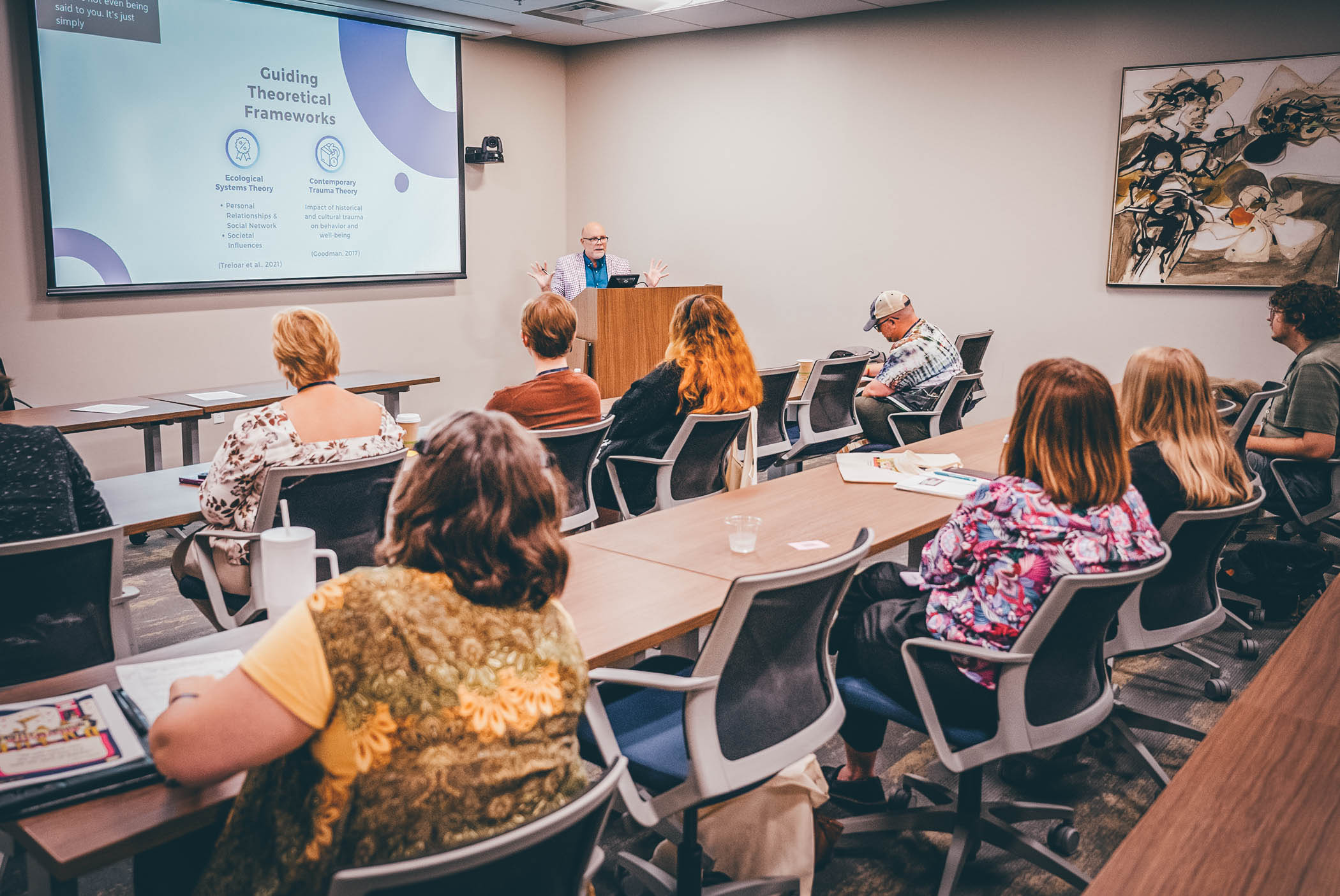 Attendees listen to a session speaker in a classroom.