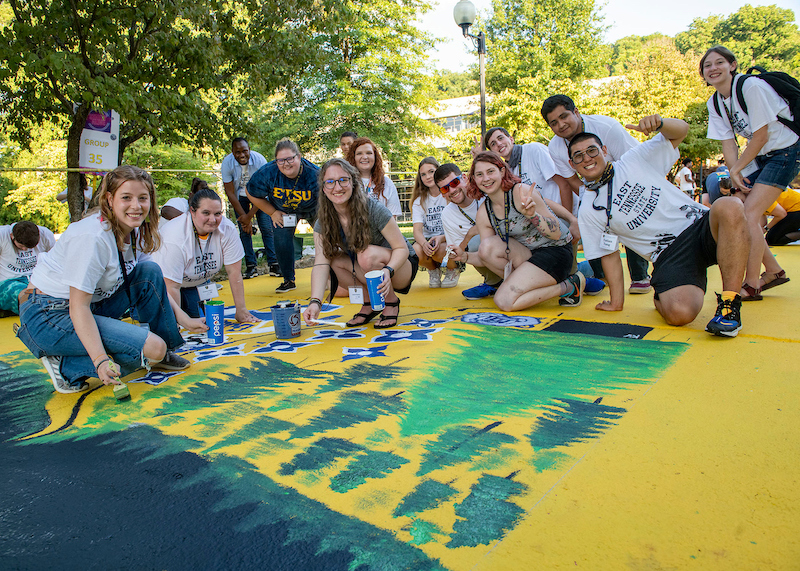 Students painting pridewalk
