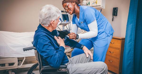 An ETSU student checking a patient's blood pressure