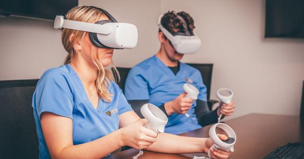 Two ETSU nursing students using virtual reality equipment for hands-on training
