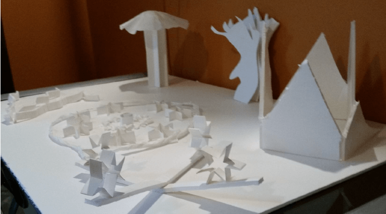 An image featuring various what paper construction, such as a house, stars, and a tree.