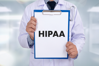 Man holding a clipboard that says "HIPAA"